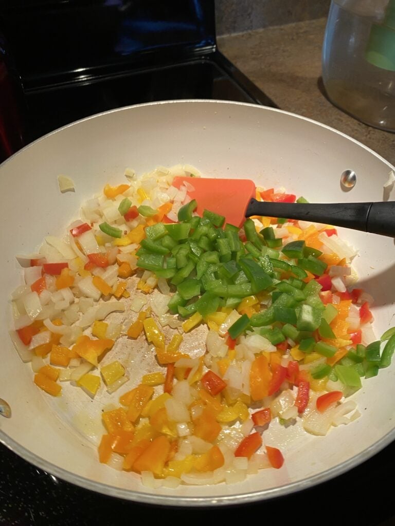 Diced peppers cooking in a pan