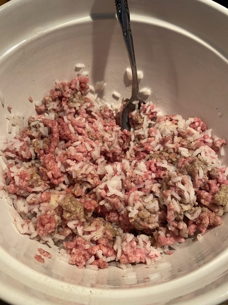 Raw, seasoned ground beef mixed with rice