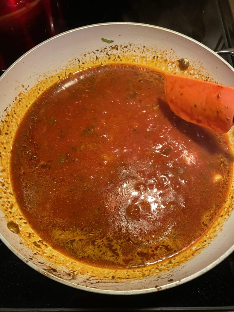 Red sauce cooking in a pan