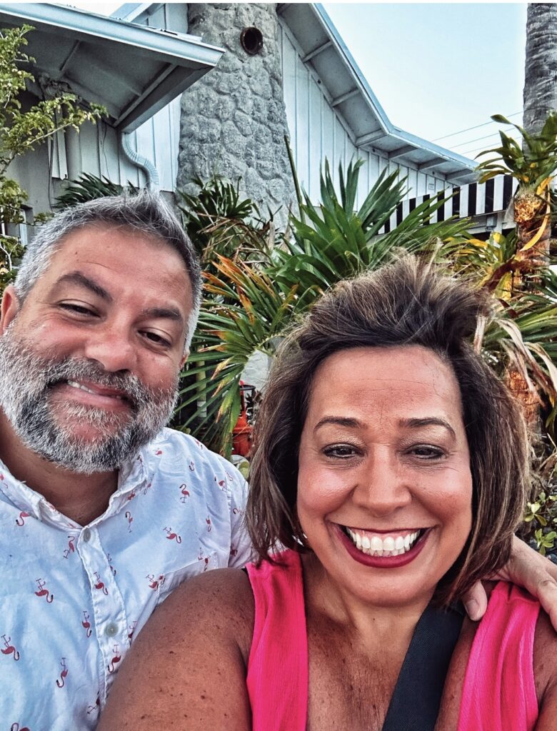 Mr. Tipsy and me in front of a house and tropical plants.