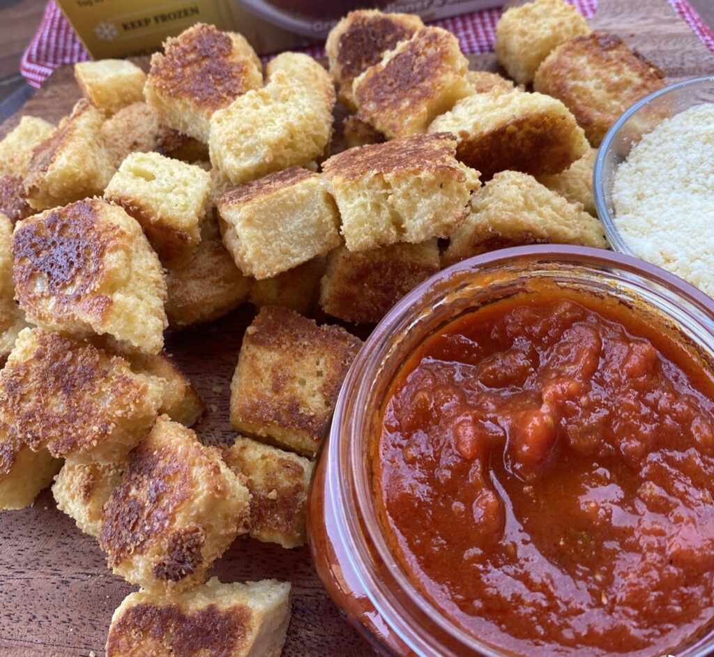 Cheesy parmesan dippers next to marinara