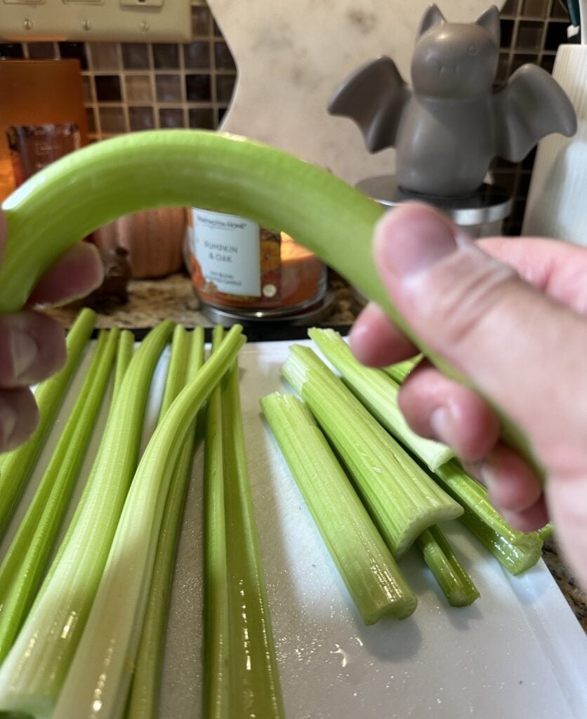 Celery being bent between fingers