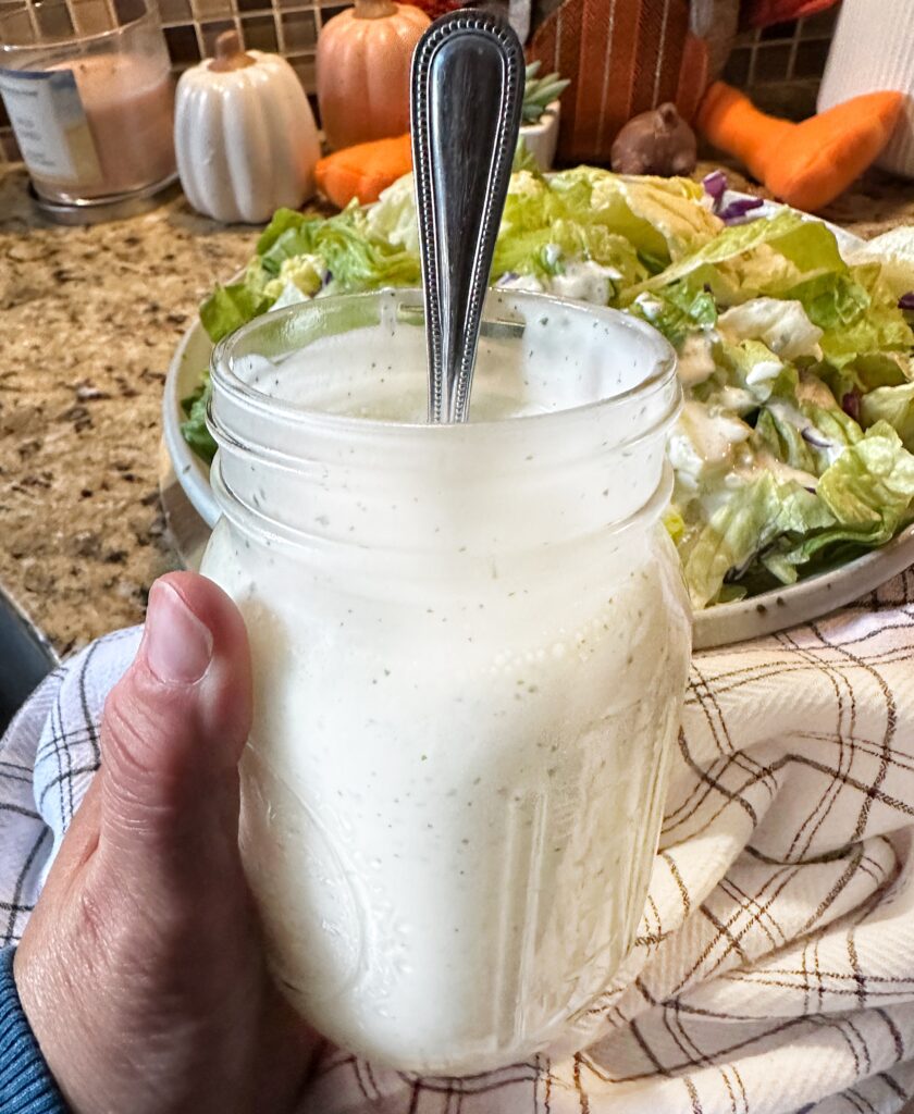 A mason jar with Aloha dressing and a spoon