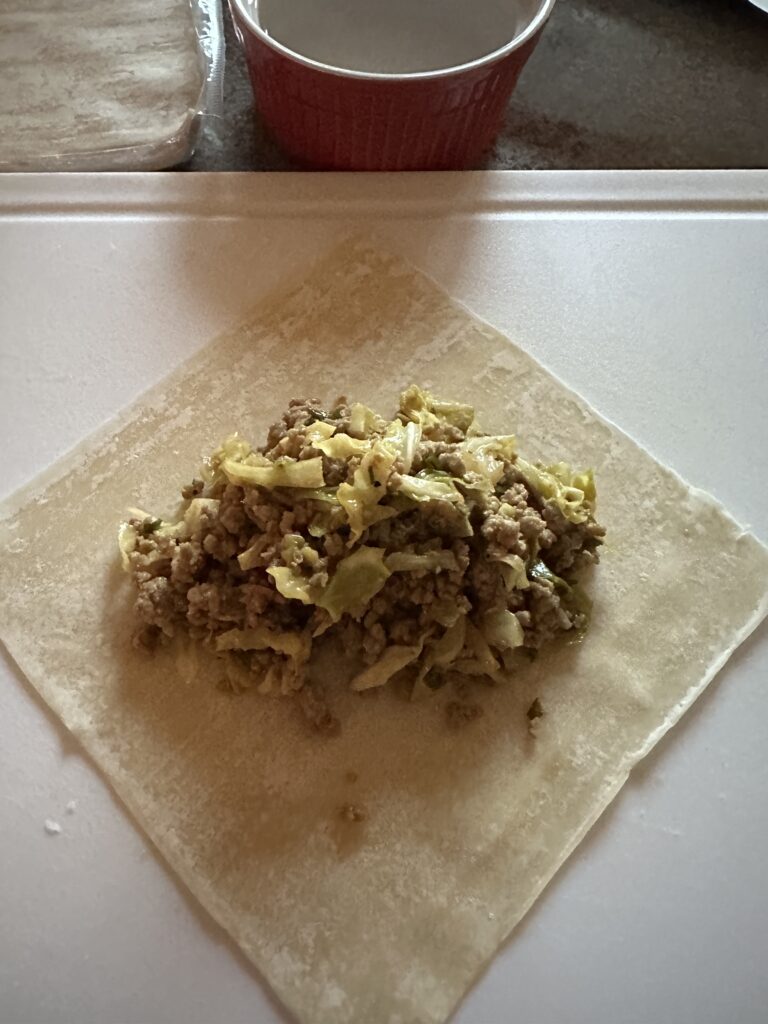 Egg roll filling on a raw egg roll wrapper