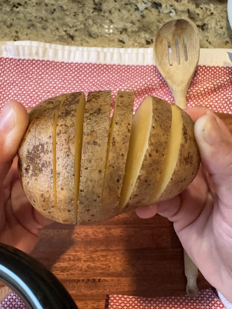 The sliced potato being fanned out