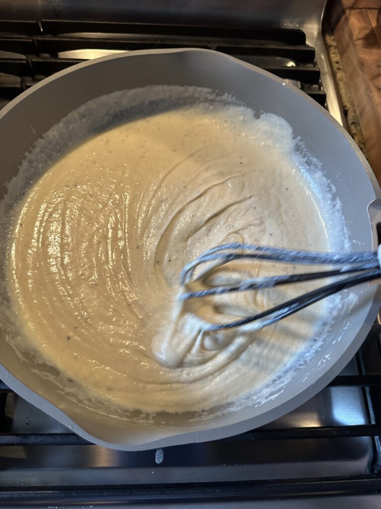 Cheese sauce in a bowl being whisked