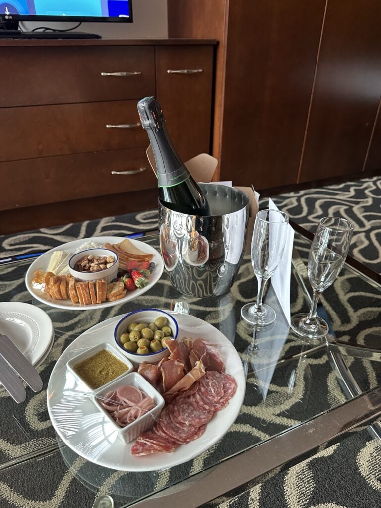 Champagne, charcuterie, and cheese in a hotel room