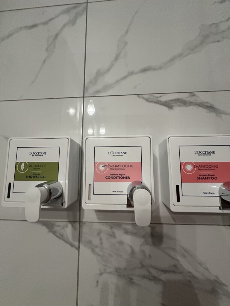 Wall-mounted shower dispensers for shower gel, conditioner, and shampoo