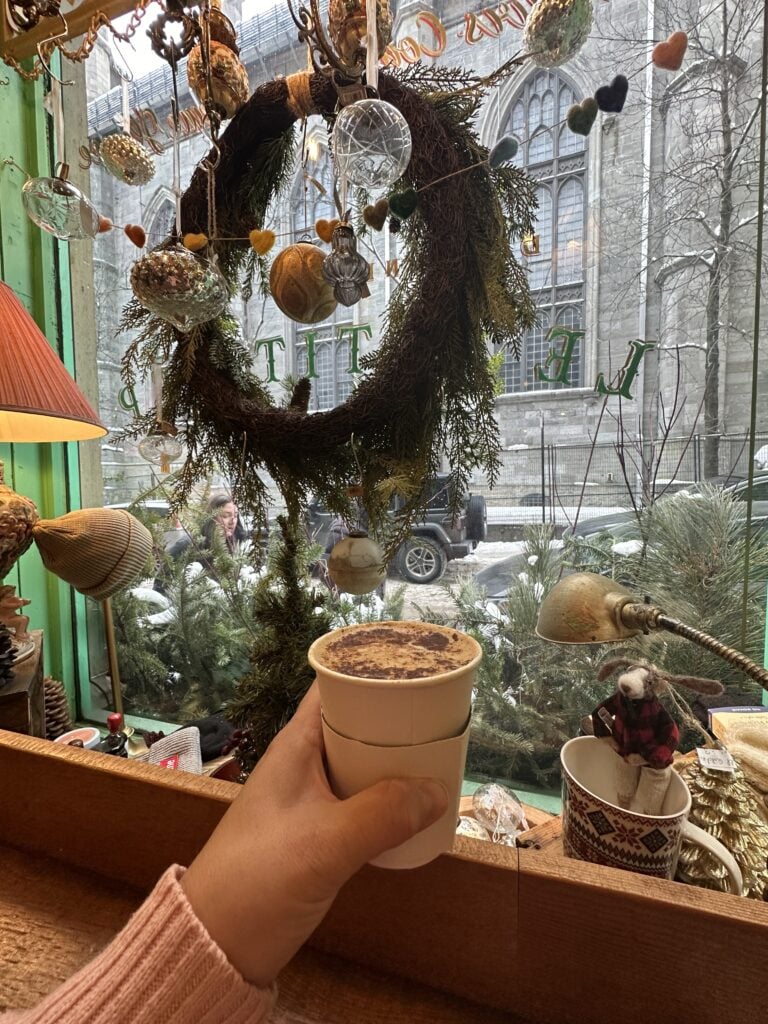 The entire of Le Petit Dep coffee house and a cup of coffee in my hand