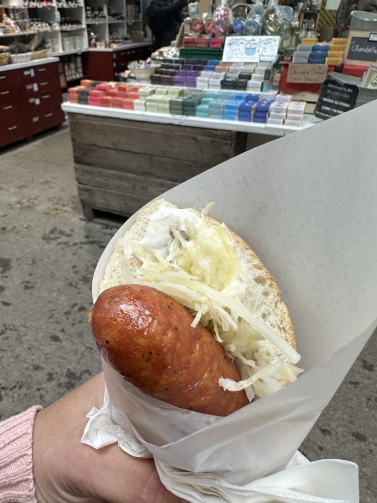 Sausage in a roll with kraut and white sauce