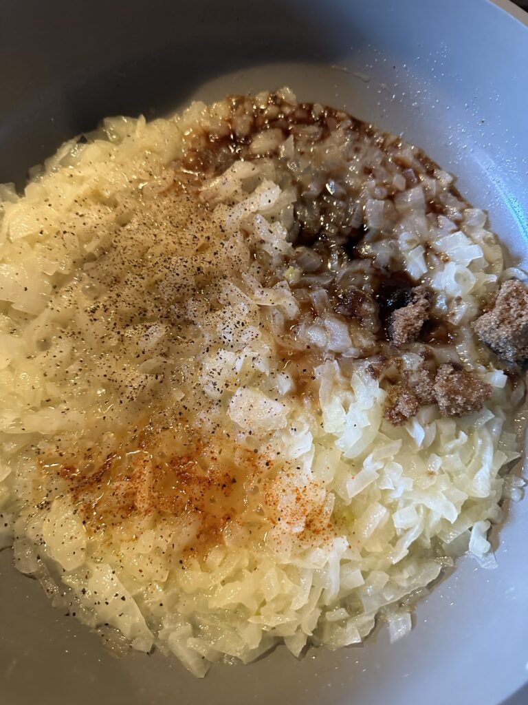 The onion and seasonings cooking together in the pan