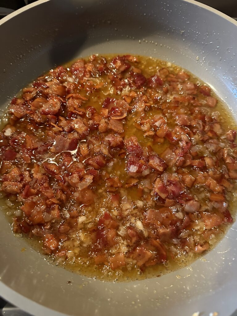 Jam, bacon, and onion sizzling in a pan