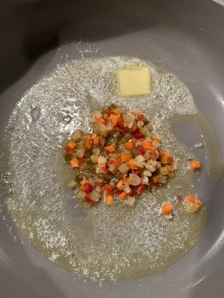 Giardiniera and butter sizzling in a pan