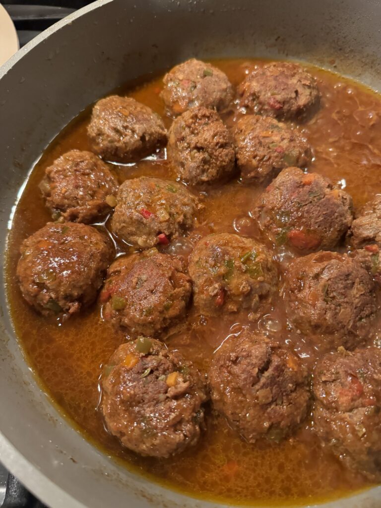 Italian meatballs cooking in sauce