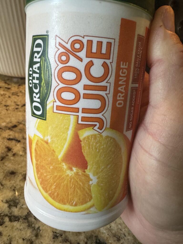 A container of old orchard orange juice