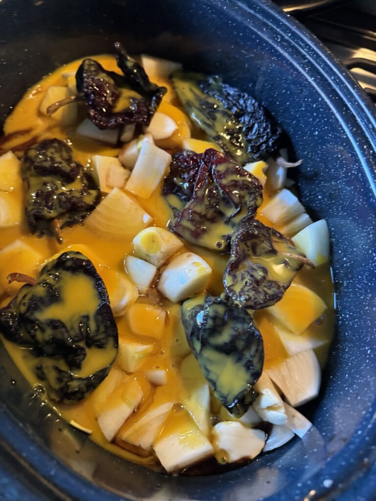 Peppers, onions, and garlic marinating in orange juice