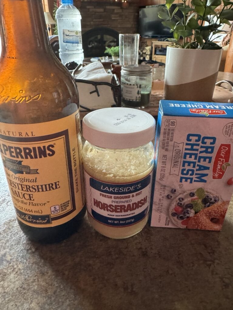 Worcestershire Sauce, Horseradish, and cream cheese next to each other on a counter