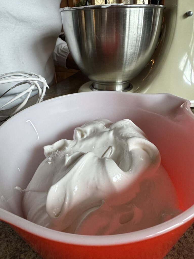 The merengue set aside in a small red bowl