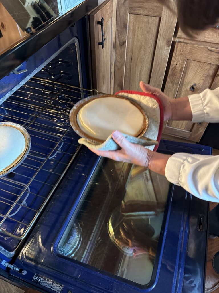 My mom removing the cheesecake from the oven