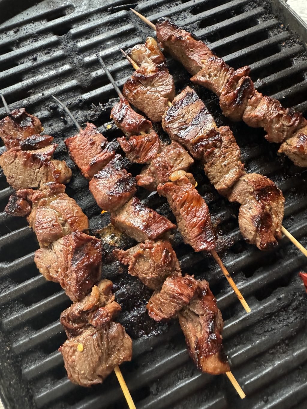 Beef skewers cooking on the grill