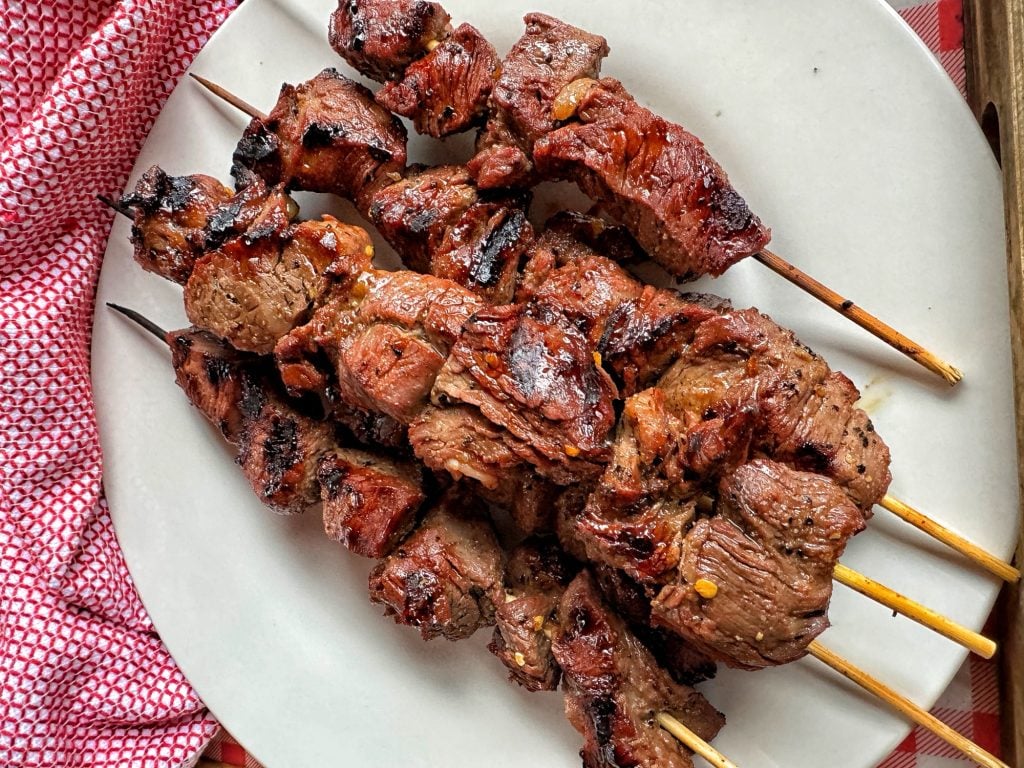 Seasoned grilled beef skewers on a plate