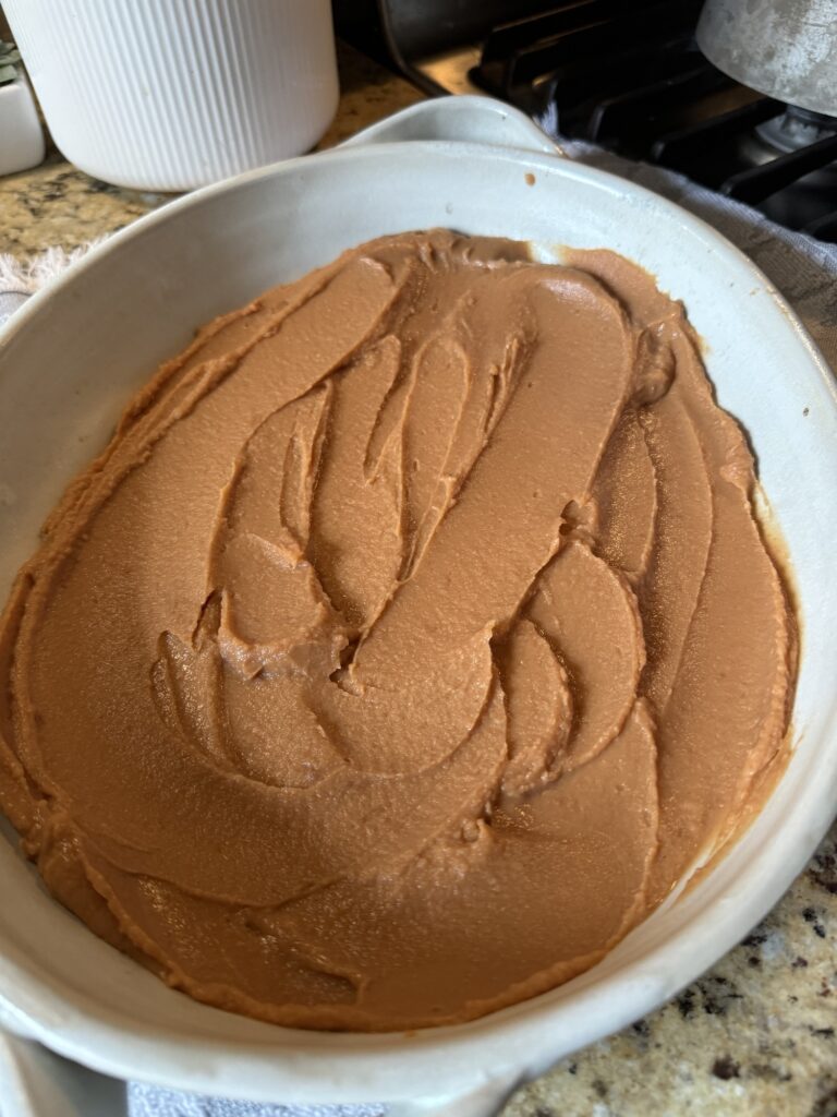 Fritos dip spread across the bottom of a baking dish