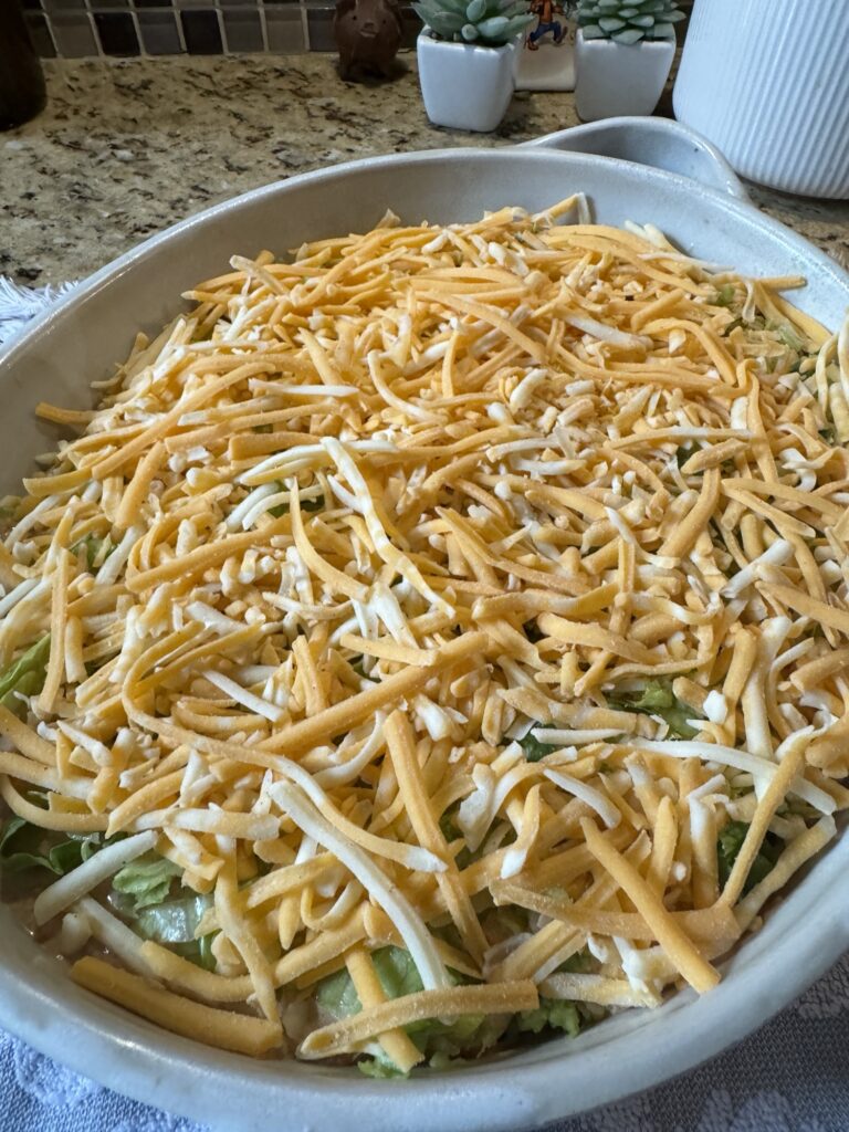The shredded cheese spread over the  rest of the dip
