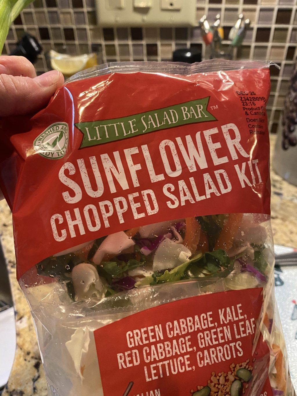 A bag of Little Salad Bar brand Sunflower Chopped Salad kit with green cabbage, kale, red cabbage, green leaf lettuce, and carrots