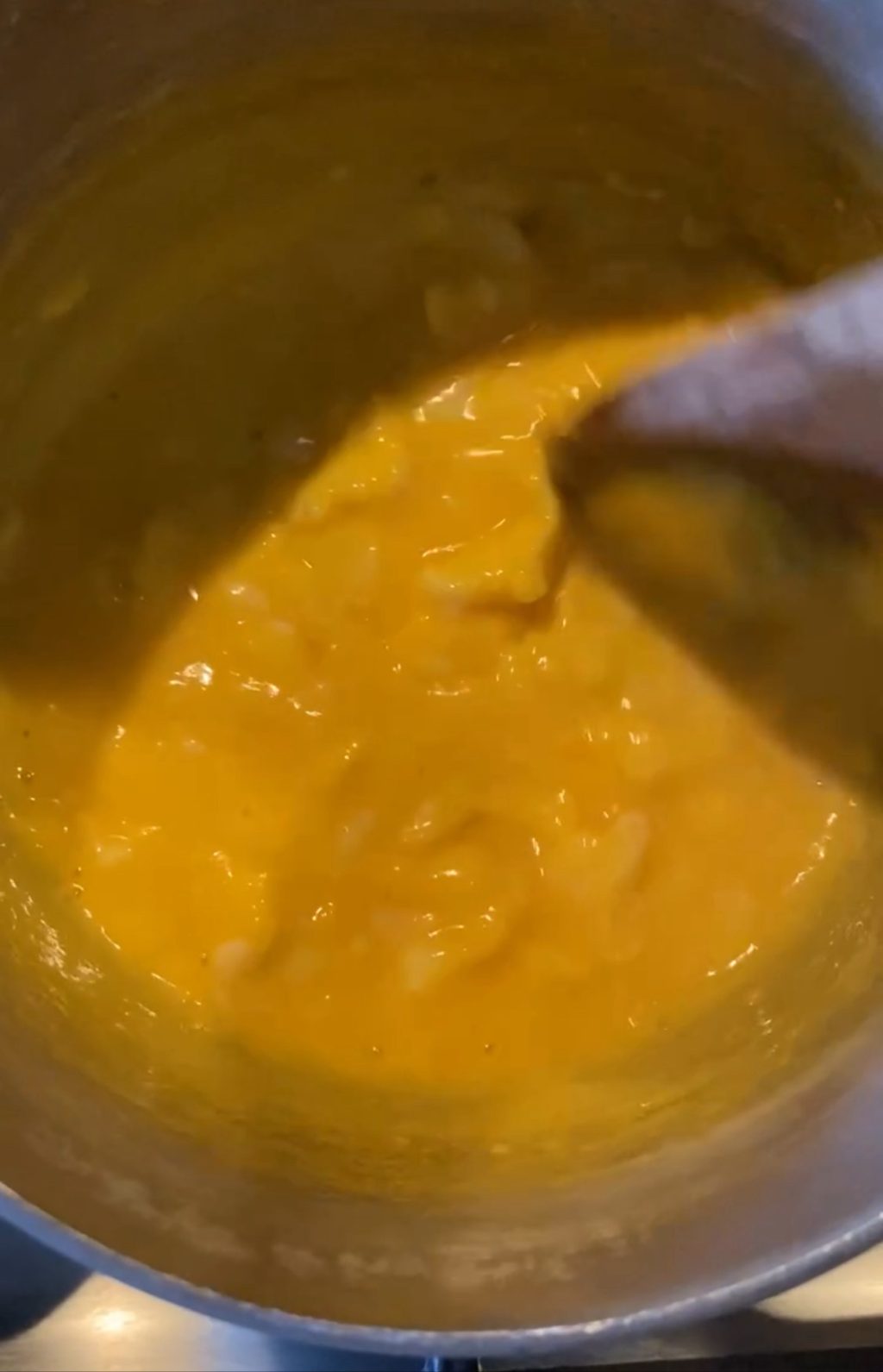 Eggs cooking in a pot, partially solidifying