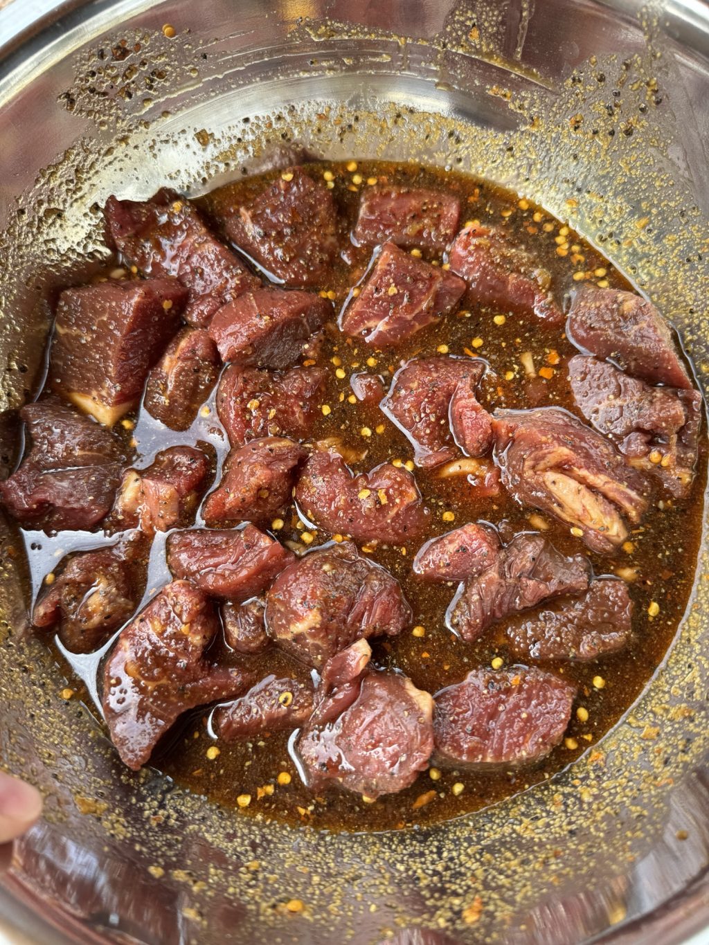 Raw beef cubes soaking in marinade