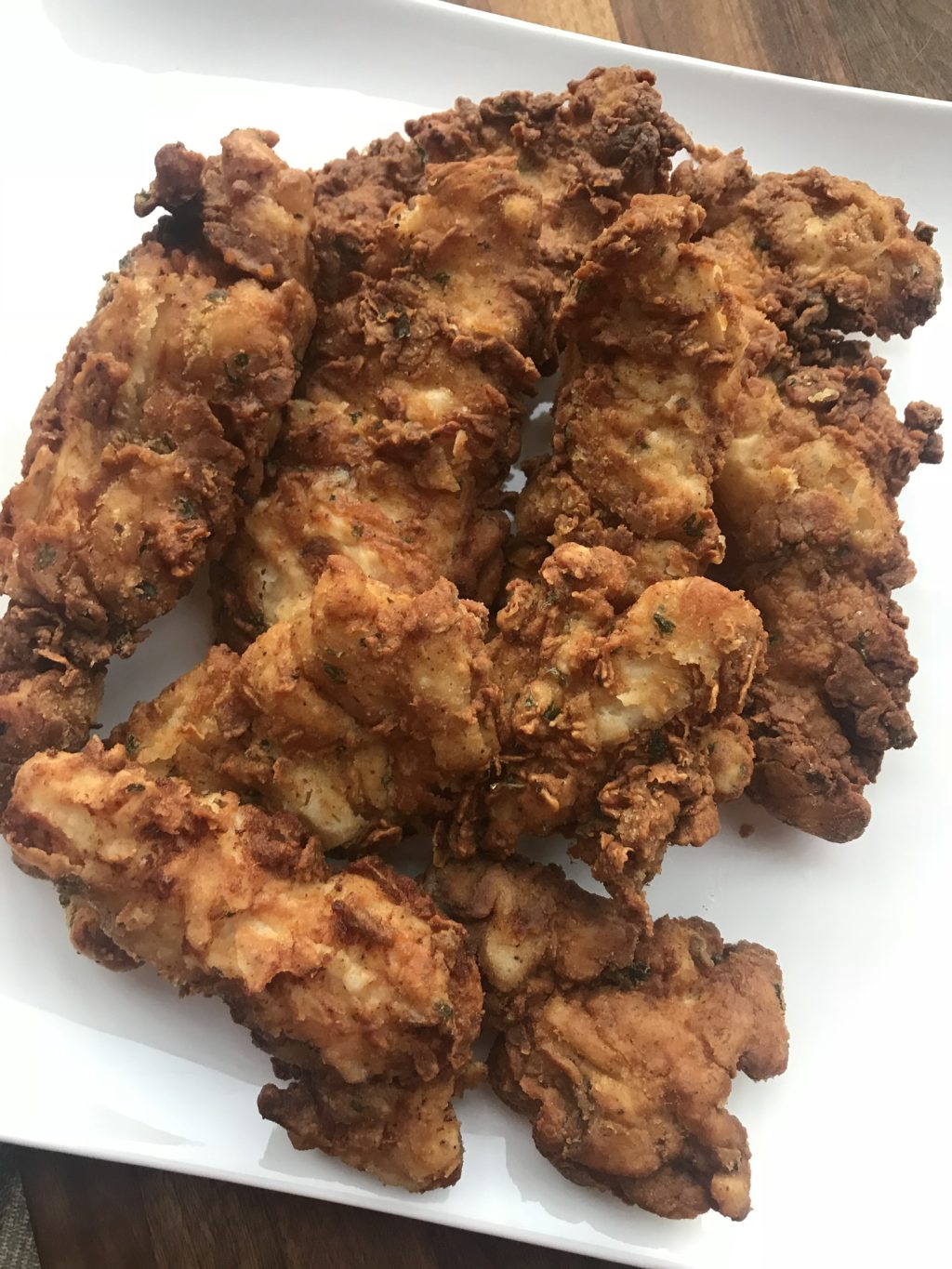 Fried chicken breasts on a white plate