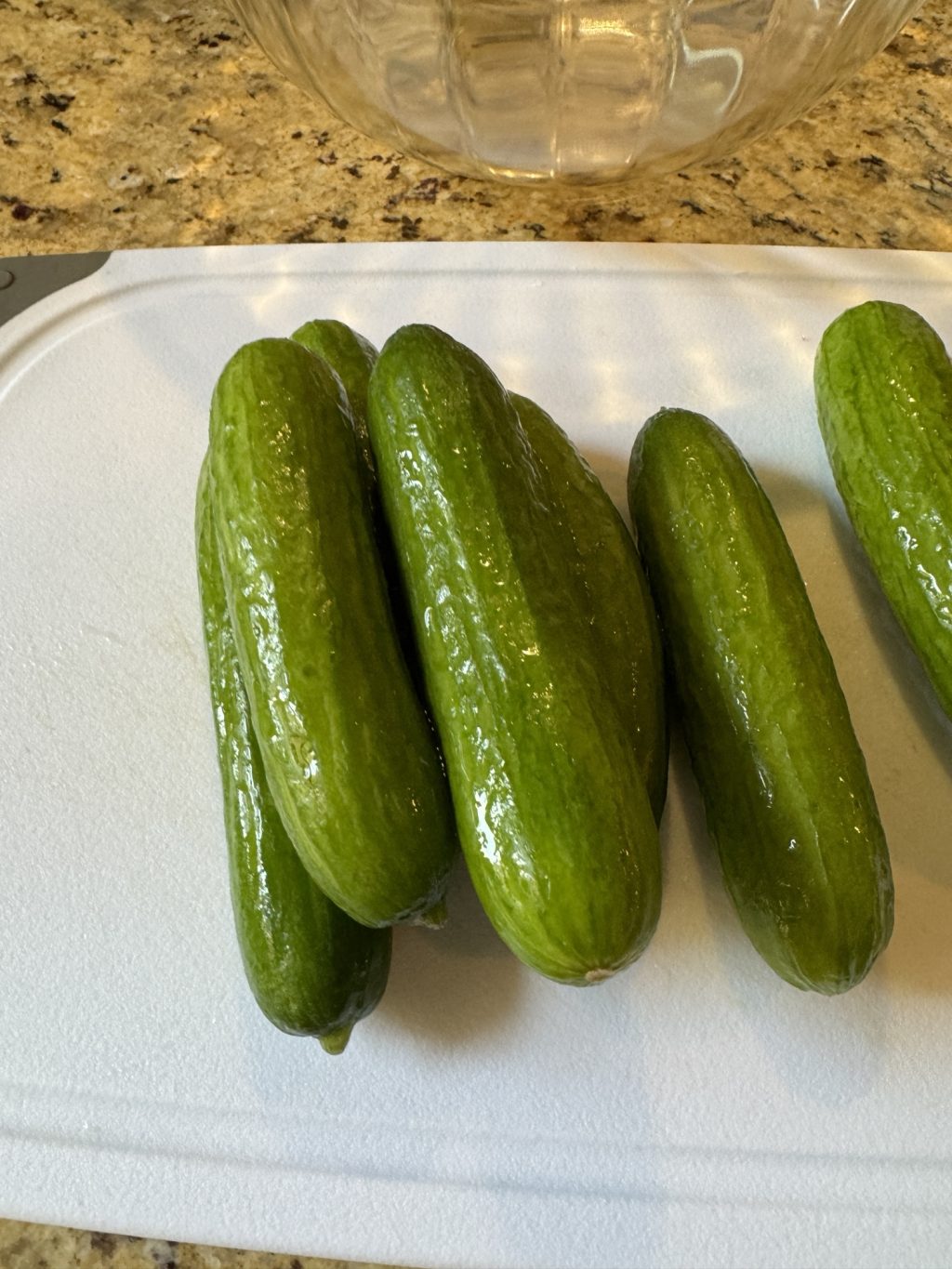 Cucumbers on a white cutting board