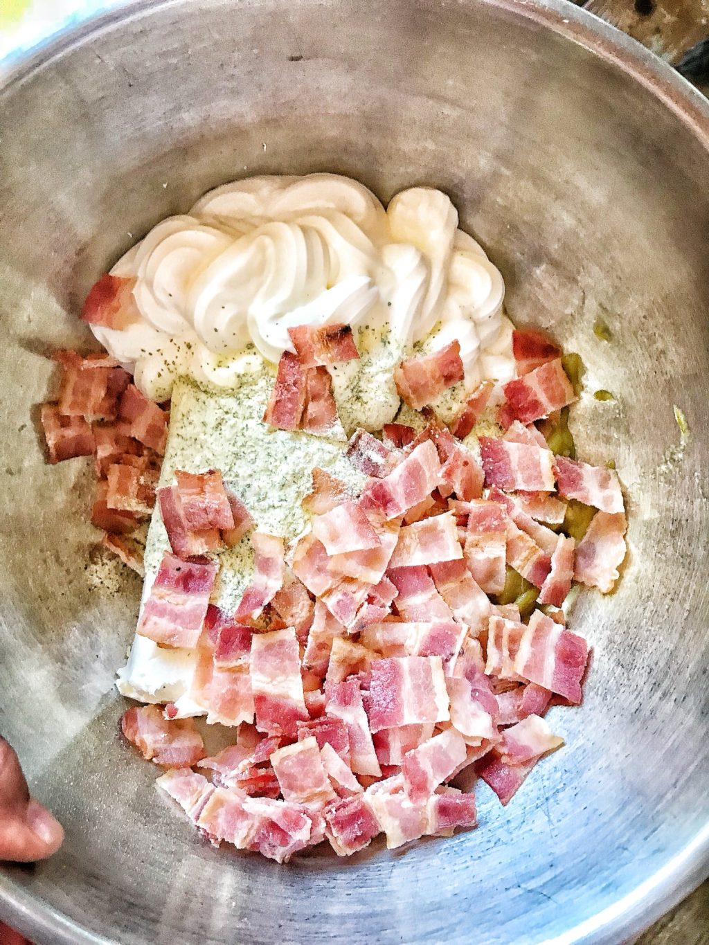 Bacon bits, sour cream, and Ranch mix in a bowl