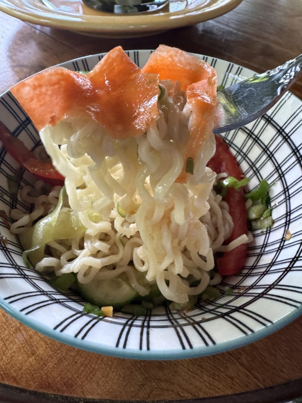 A forkful of cold ramen salad with carrot