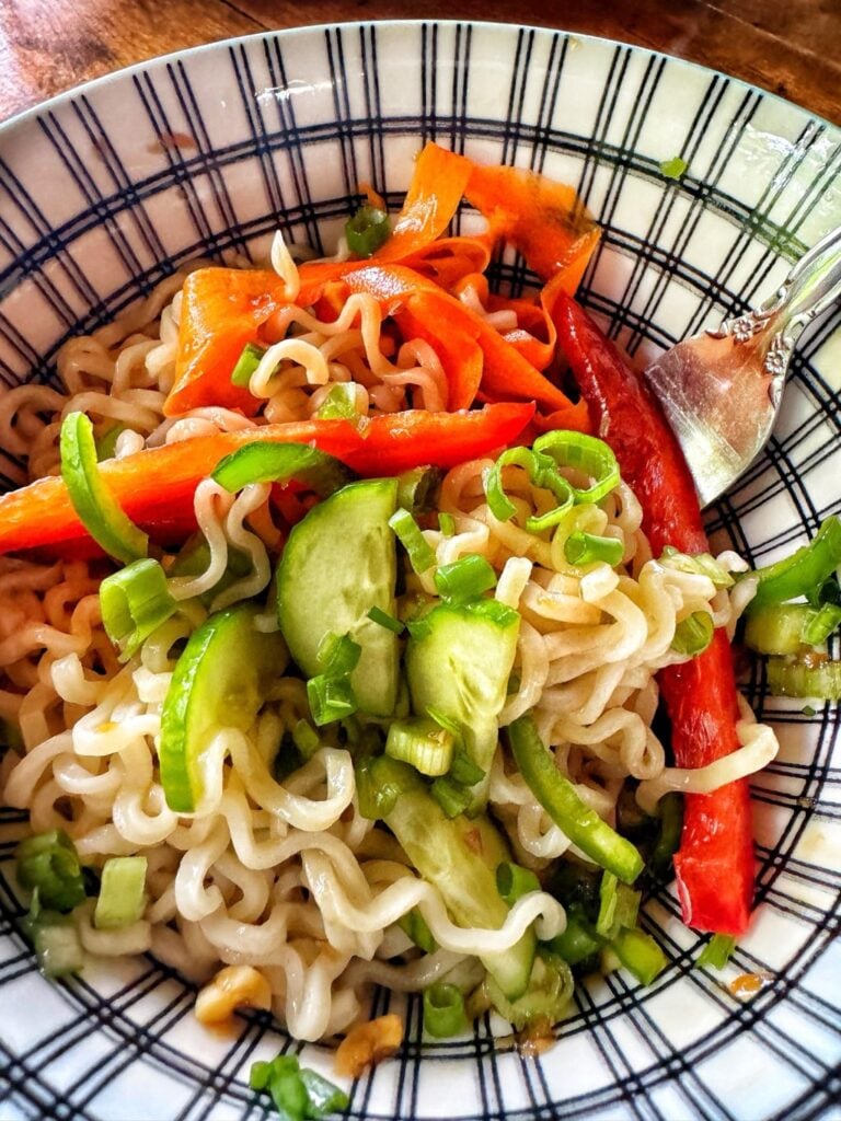 Cold ramen noodle salad in a bowl with a fork.
