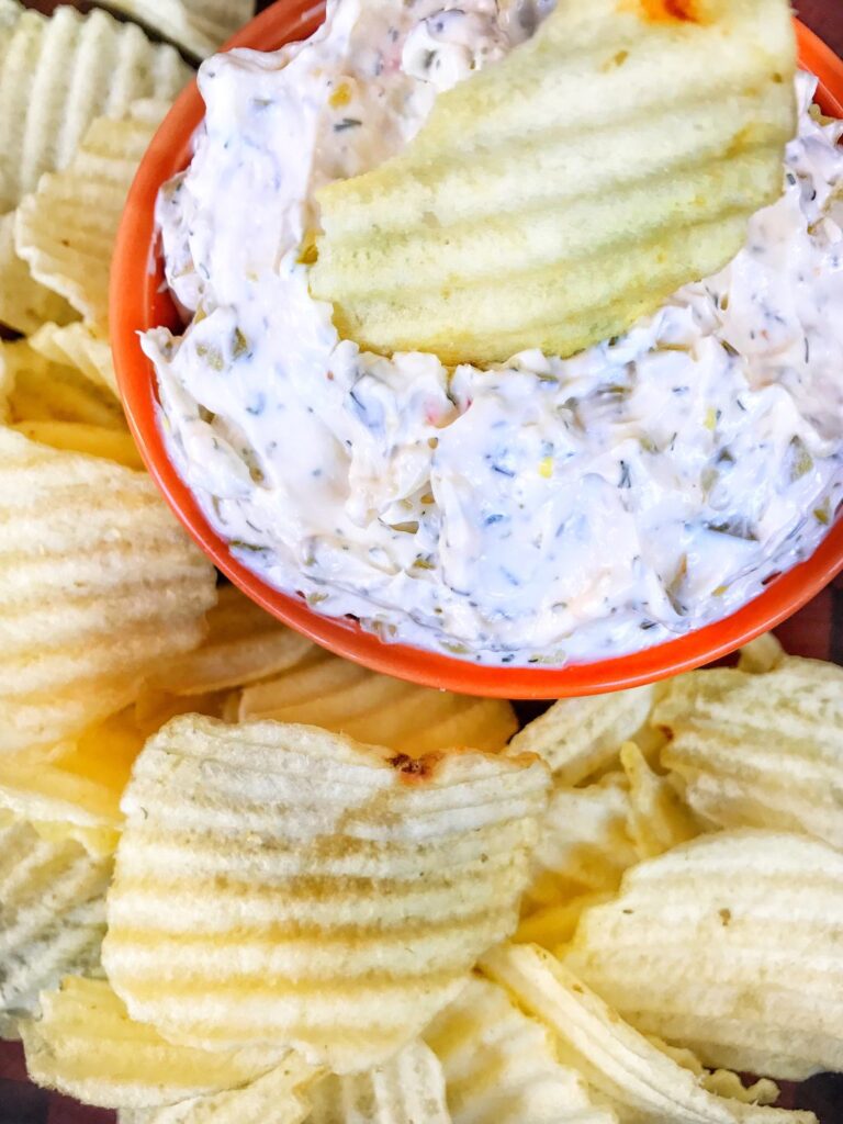 A chip placed on a white dip surrounded by more chips