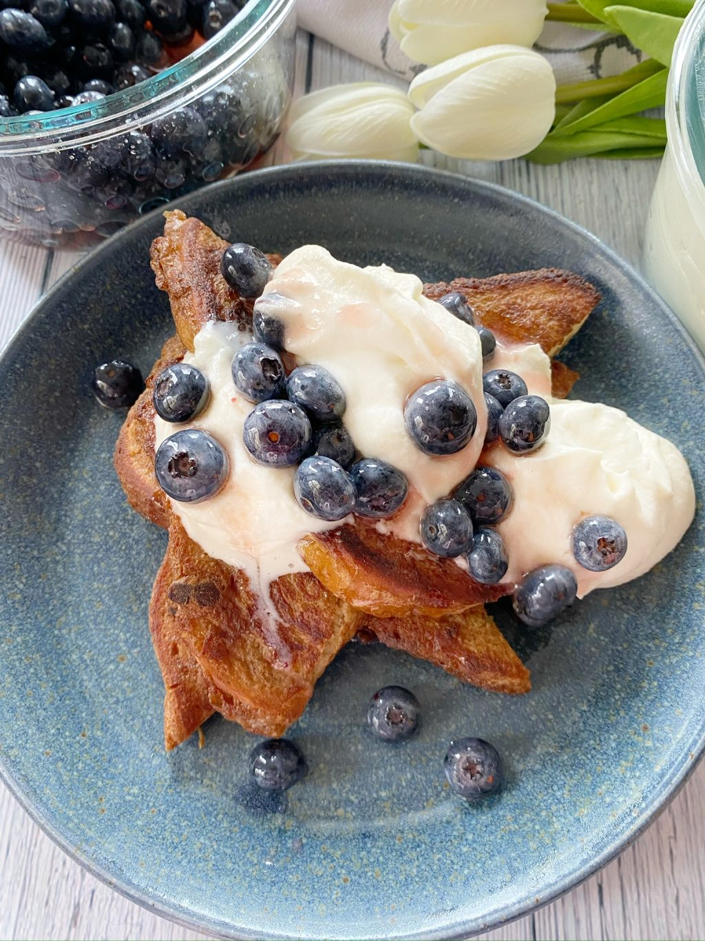 Macerated blueberries over whipped cream and french toast