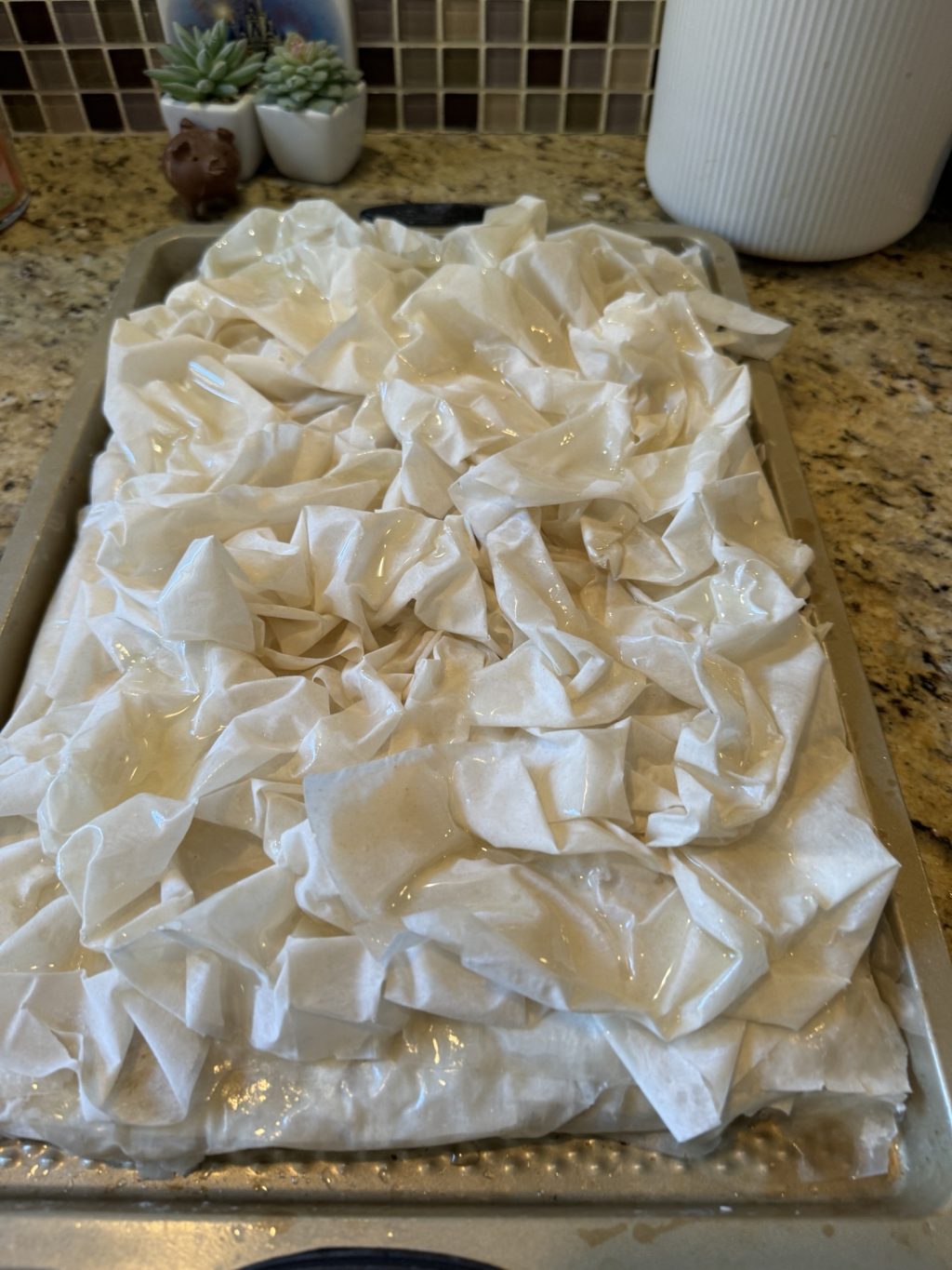 A layer of scrunched up Phyllo dough has been placed on the rest of the dough