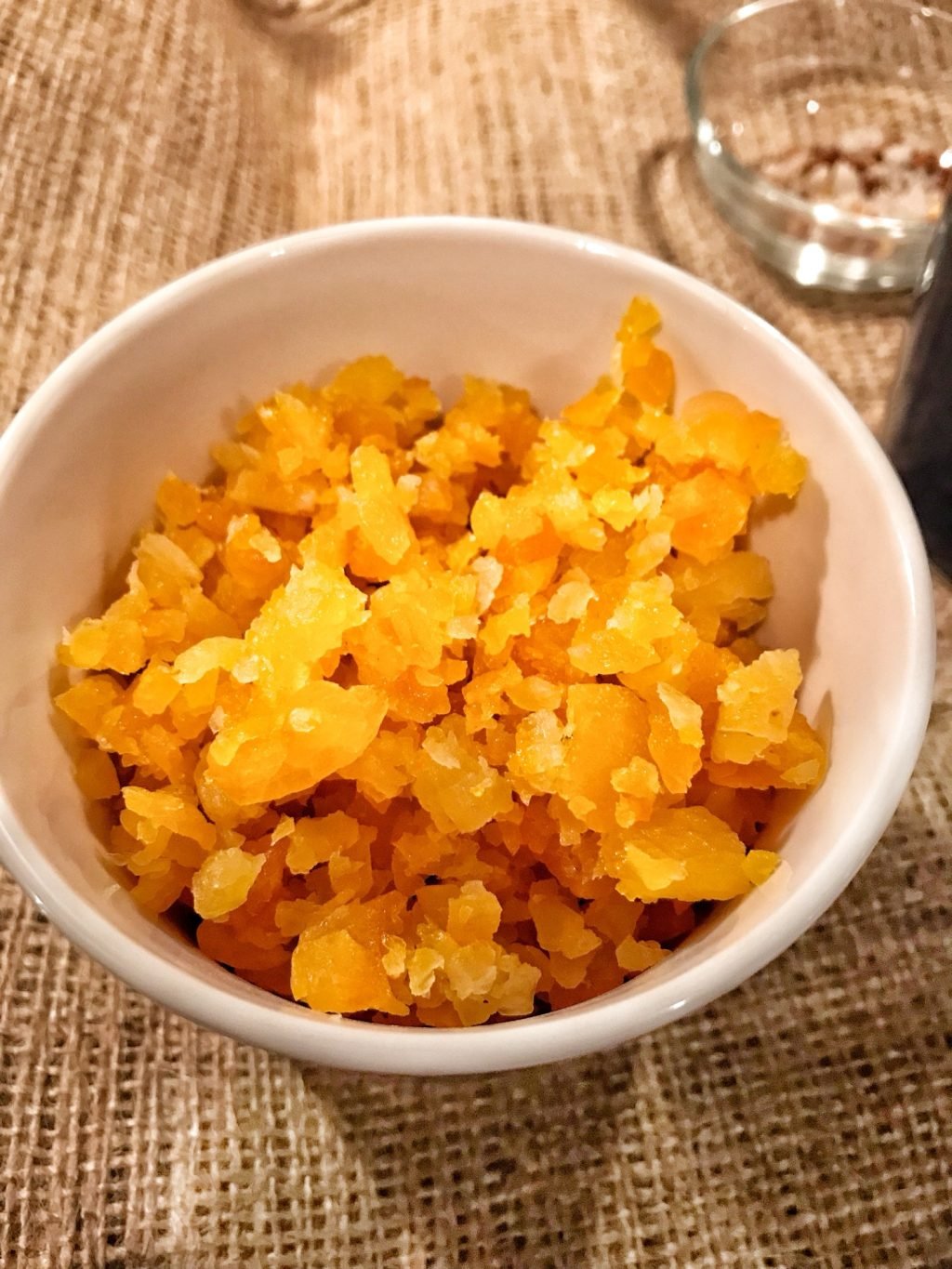 A small white cup of apricot crumbles