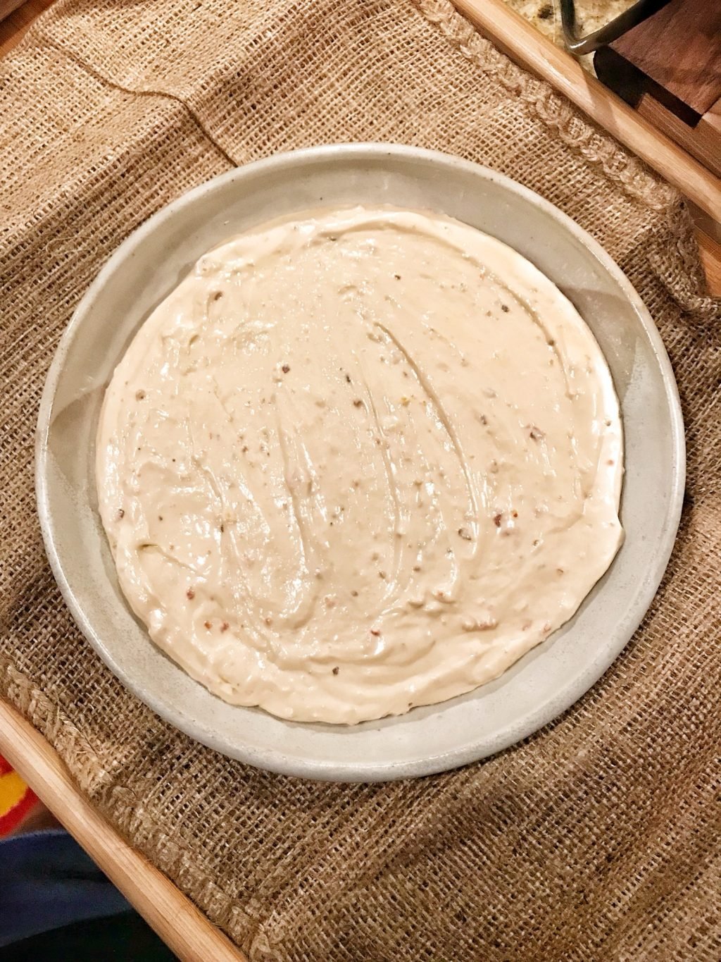White spread with red flakes in a bowl