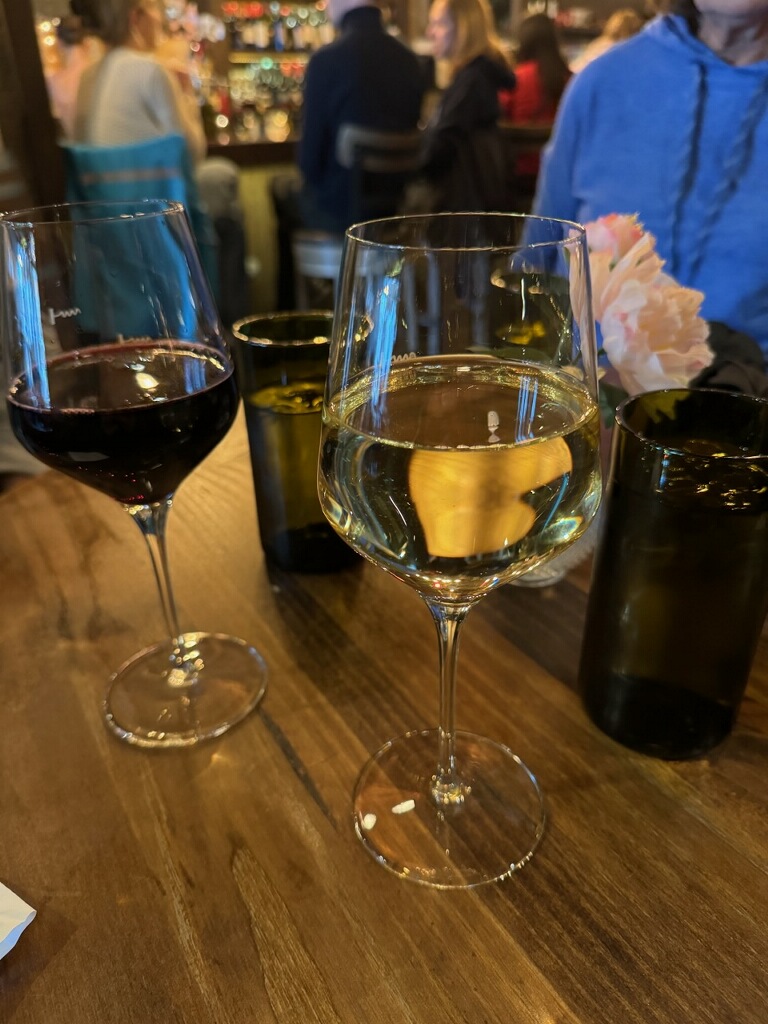 A glass of white wine next to a glass of red wine