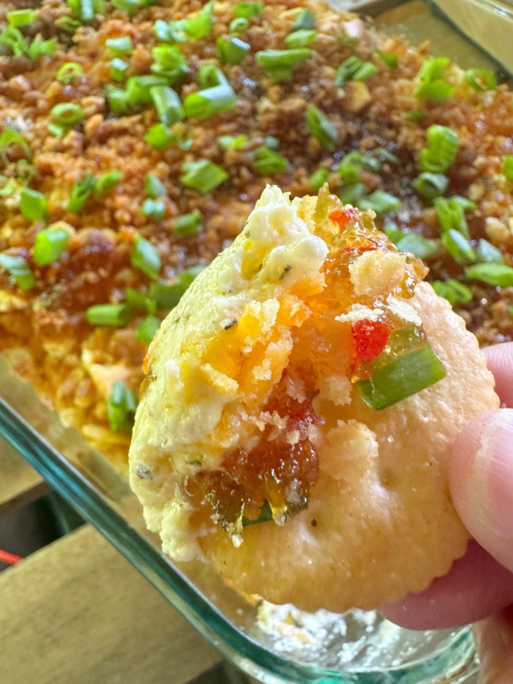 A Ritz cracker that has been dipped into Party Dip