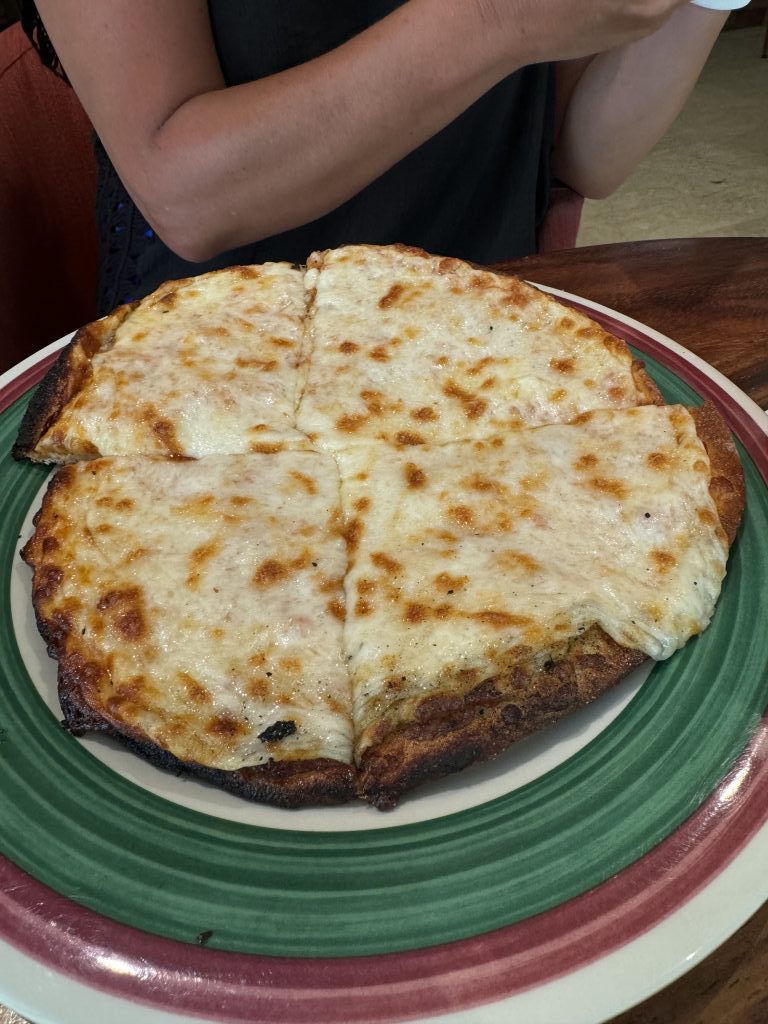 A pizza cut into four quarters.