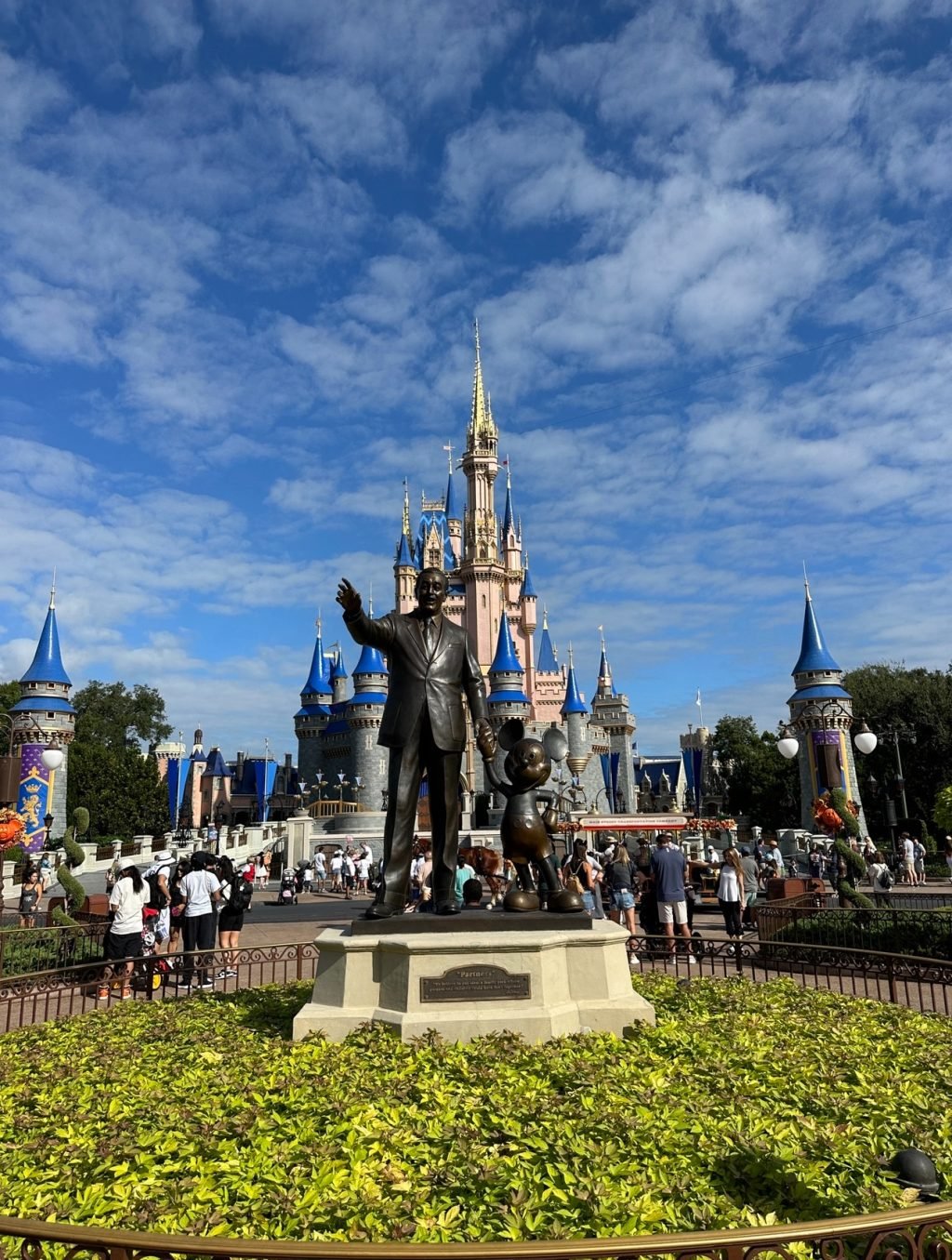 The statue of Walt Disney and Mickey in front in front of the Magic Kingdom castle.