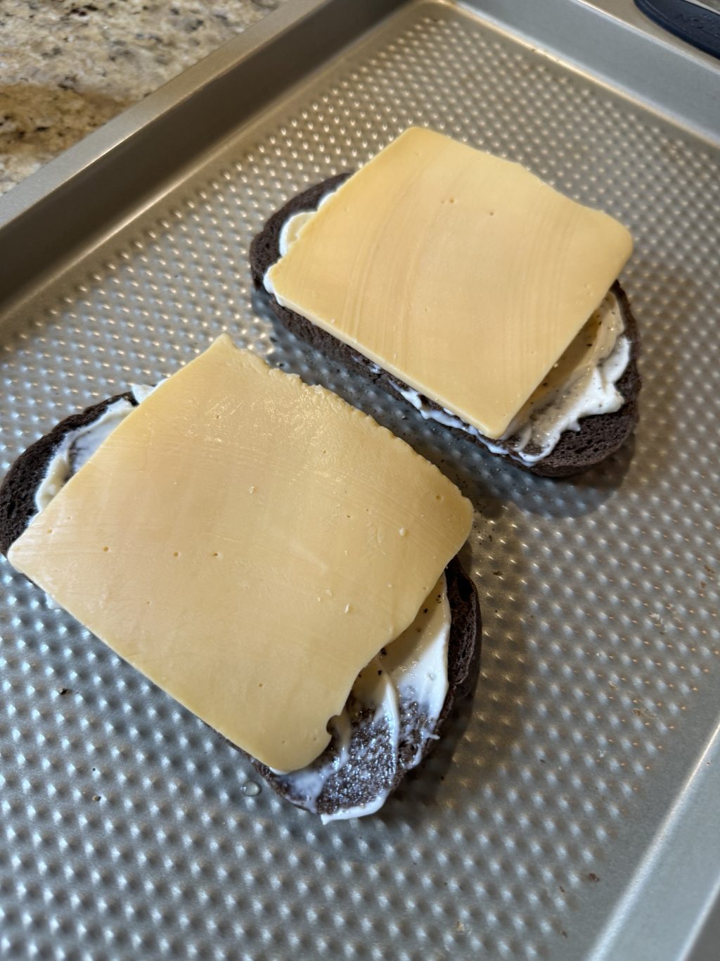 The two slices of bread covered with a slice of American cheese, each.