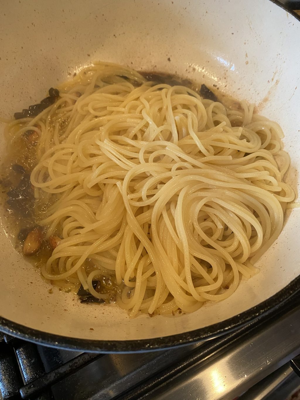 Spaghetti in a pan with sauce.
