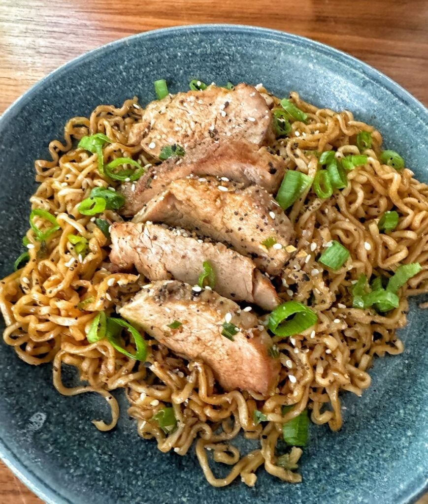 Sliced pork over ramen noodles.