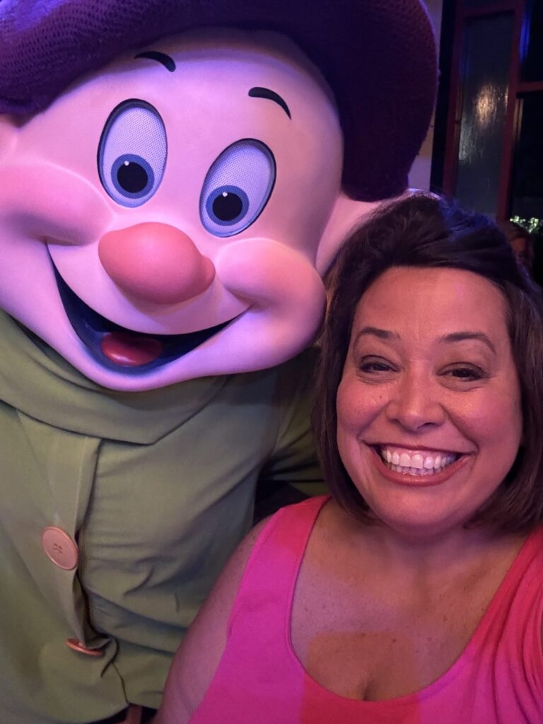 A selfie I took with a person in a Dopey costume. 
