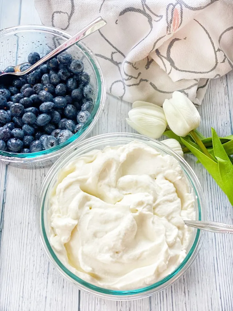 Whipped cream and a bowl of berries.