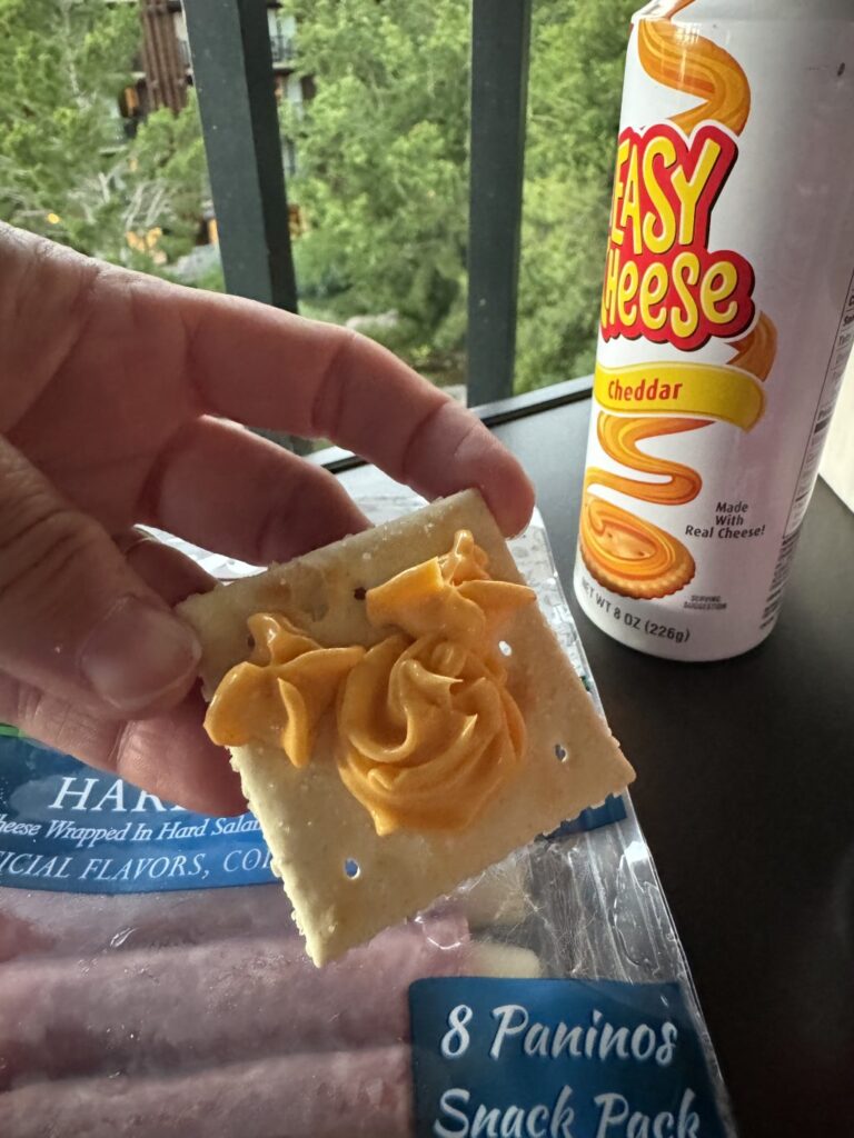 A cracker with a Cheeze Whiz Mickey logo sprayed on it.
